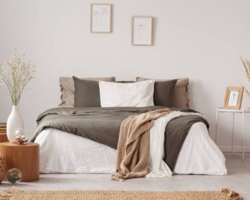 Spacious bedroom interior in beige and olive colour