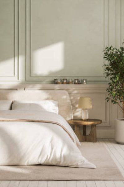 Interior of a modern cozy bedroom with furniture in pastel tones.